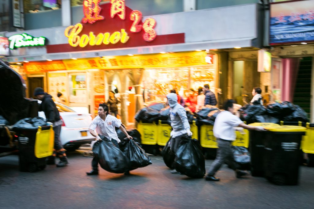 Restaurant workers hauling out trash in Flushing Queens street photography series