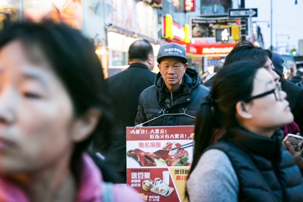 Sign board man in Flushing Queens street photography series