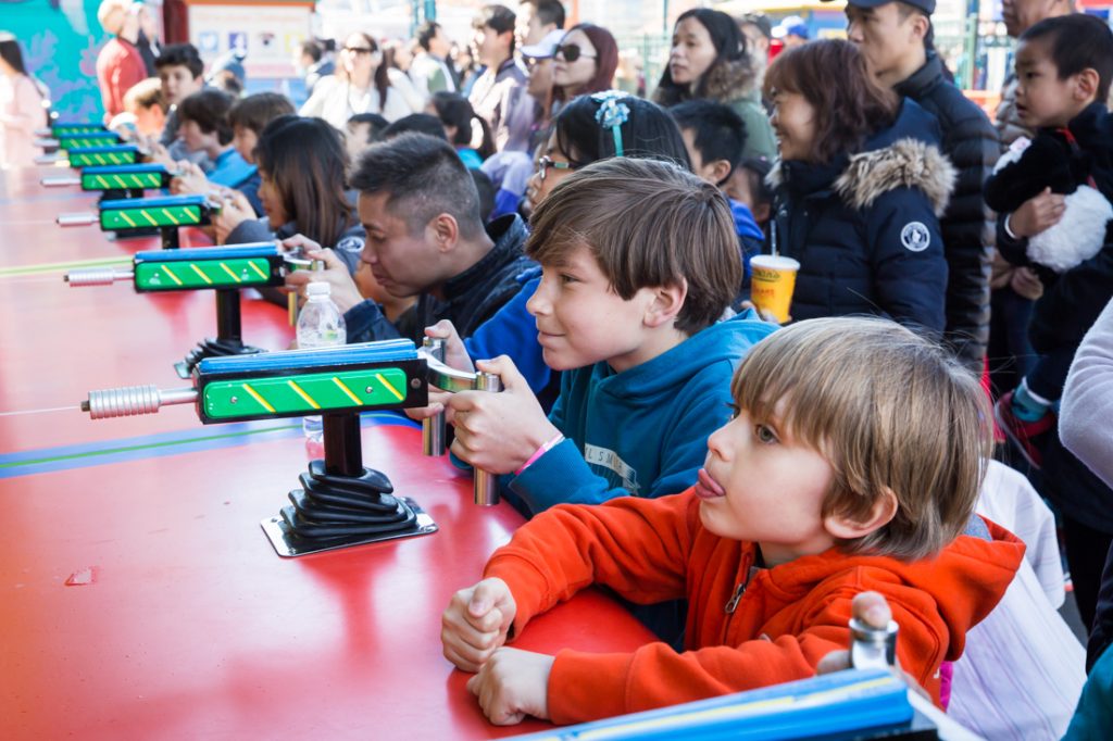 Kids playing amusement games on Coney Island opening day 2017