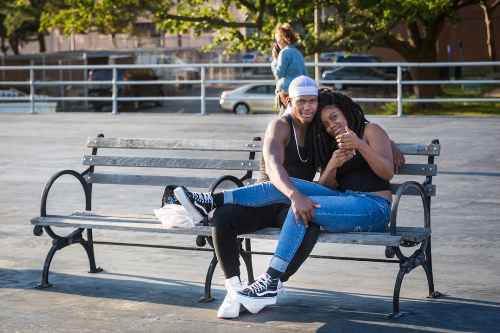 Coney Island street photography of lovers taking a selfie on the boardwalk
