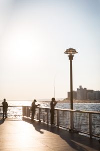 Coney Island street photography of fishermen on the pier