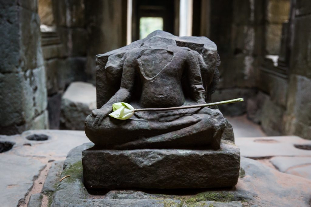 Headless sculpture at Preah Khan for an Angkor Wat temple guide