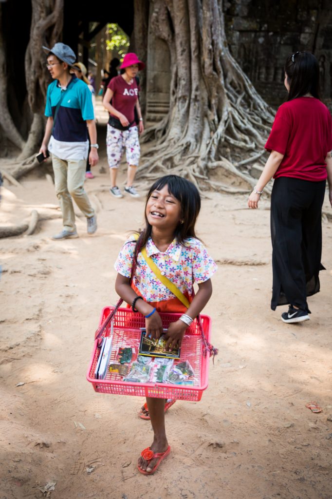 Little girl selling things at Ta Som for an Angkor Wat temple guide
