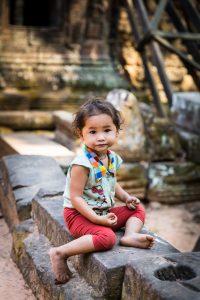 Little girl sitting for an article on Angkor Wat travel tips