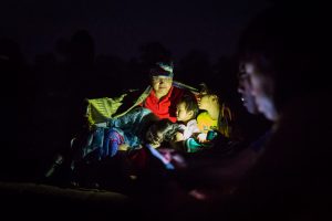 Family lit by flashlight for an article on Angkor Wat sunrise strategies
