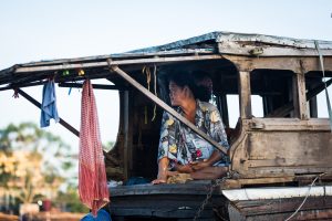 Woman sitting on boat at the Cai Rang Floating Markets