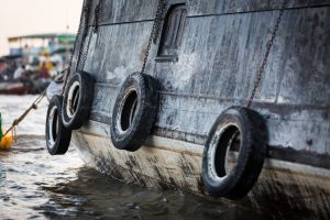 Tires on the side of a boat at the Cai Rang Floating Markets