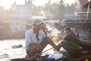 Man smoking at the Cai Rang Floating Markets