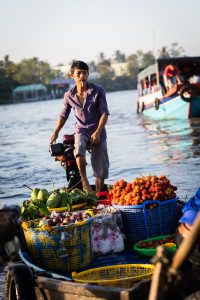 Man driving boat at the Cai Rang Floating Markets