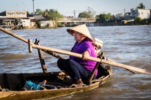 Women driving boat at the Cai Rang Floating Markets