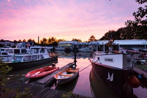Boats on a canal at sunset in Papenburg, Germany