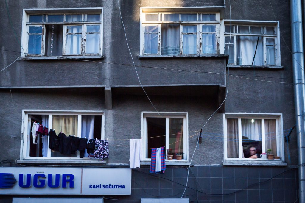 Man in window for an article on Istanbul street photos