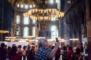 Tourist taking photos in Hagia Sophia for an article on Istanbul street photos