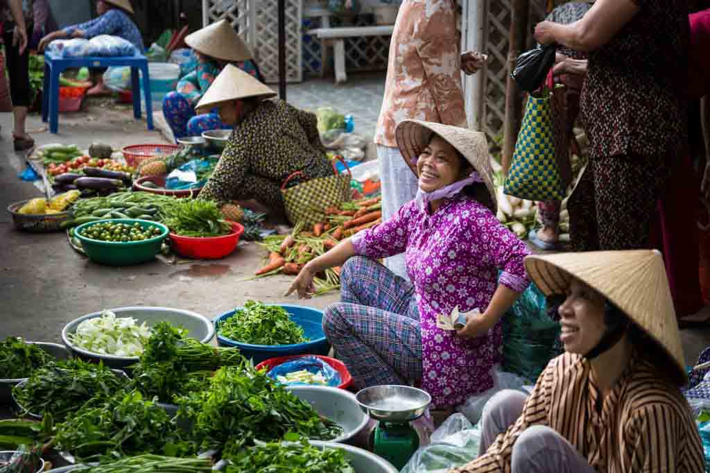 Woman selling at market for an article on the Cai Be Floating Markets