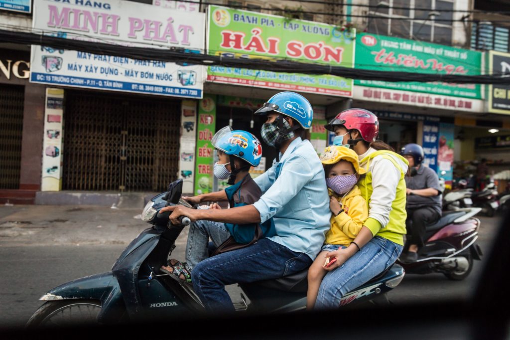 Family on a motorcycle for article on Ho Chi Minh City street photos