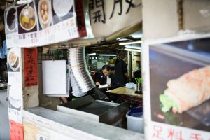 Person eating in a Hong Kong restaurant for a Hong Kong travel guide article