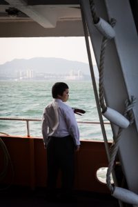 Man on ferry for a Hong Kong travel guide article