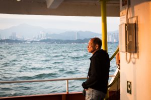 Man on ferry for a Hong Kong travel guide article