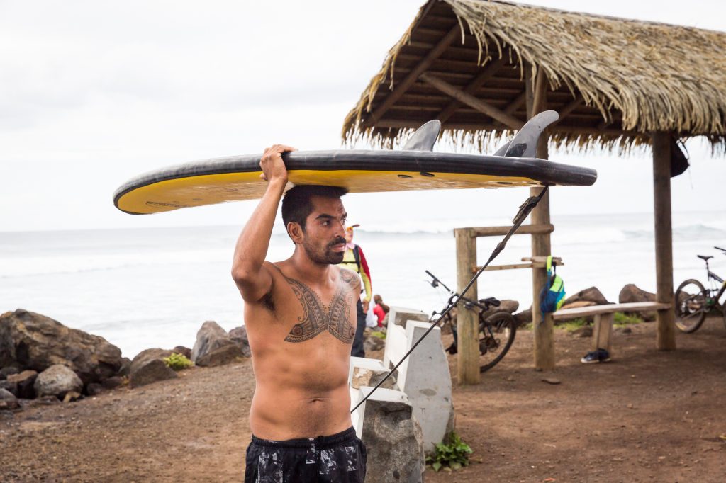 Surfer at Hanga Roa for an Easter Island travel guide