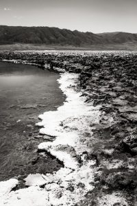 Rocks leading to mountain at Laguna Baltinache in black and white