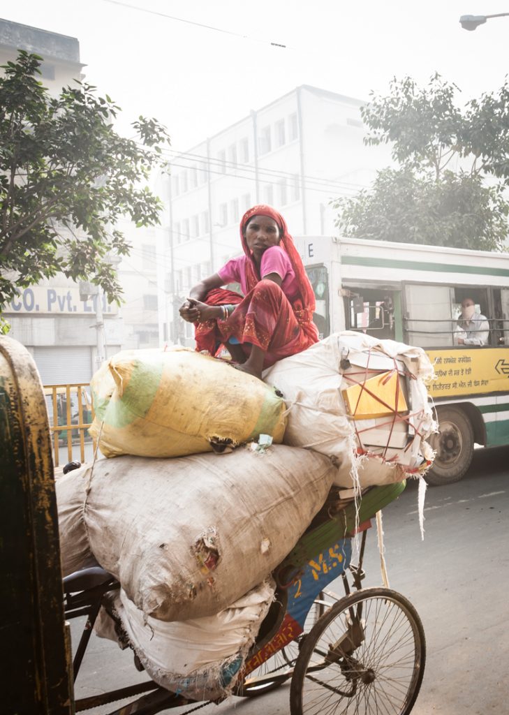 Woman sitting on a cart in India