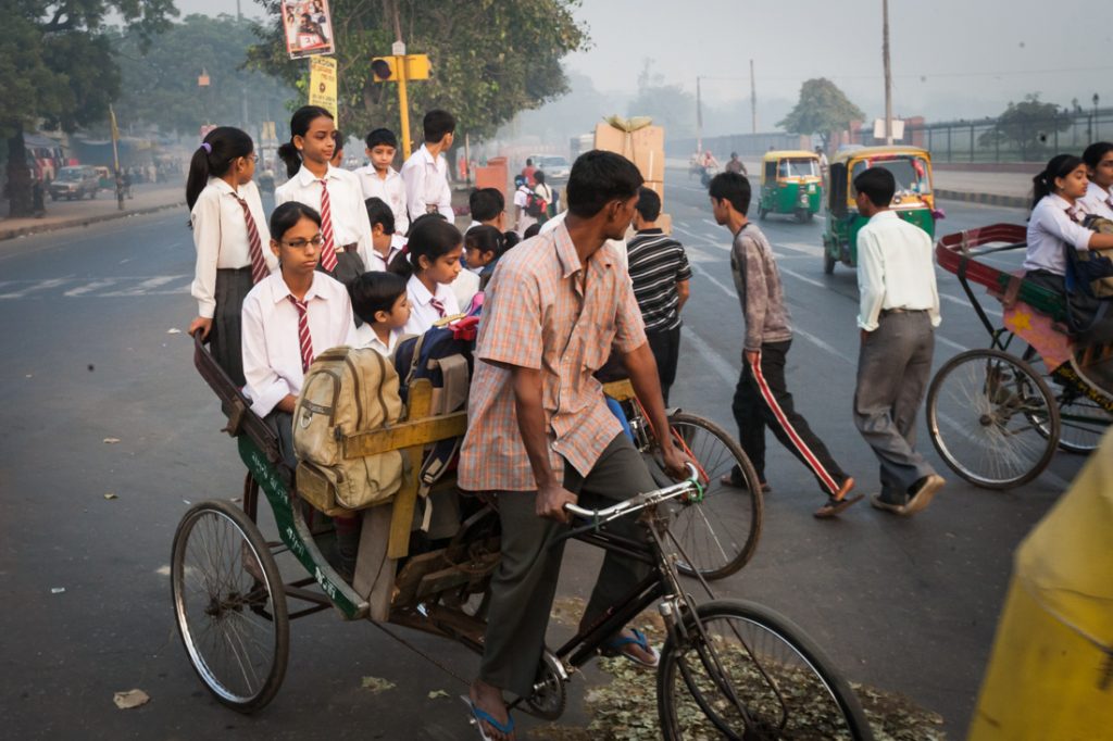 Children being driven to school in Delhi, India
