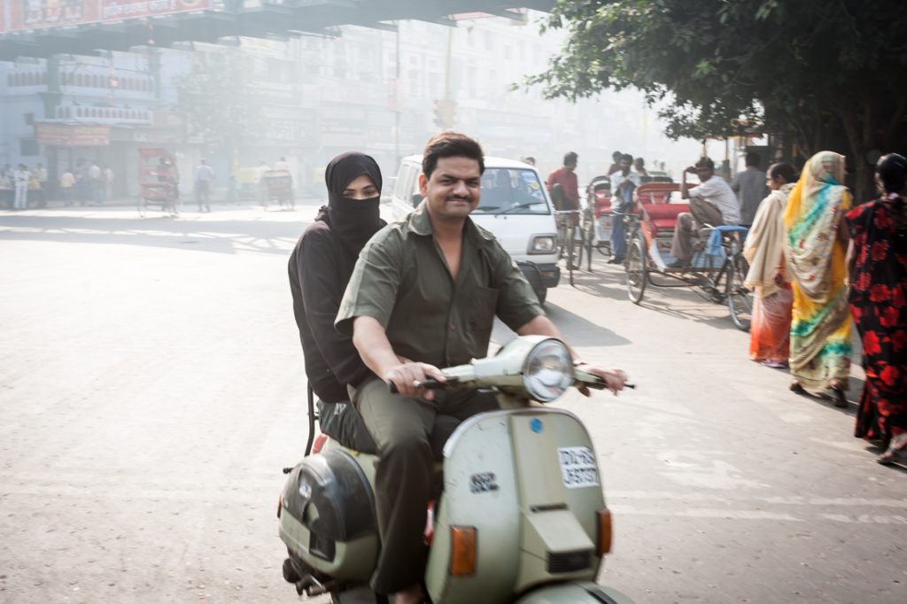 Couple on a scooter in Delhi, India
