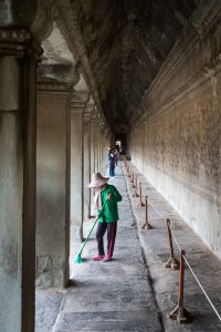 Woman sweeping temple for an Angkor Wat temple guide