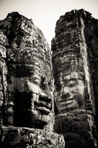Face statues at Bayon Temple for an article on Angkor Wat travel tips