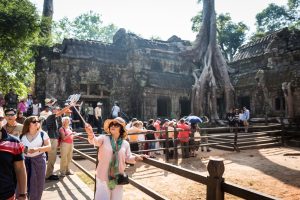 Tourists at Ta Prohm Temple for an article on Angkor Wat travel tips