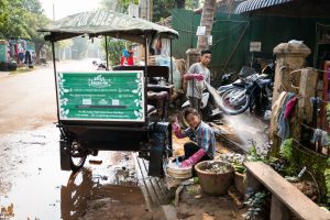 Kid washing tuk tuk for an article on Siem Reap travel tips