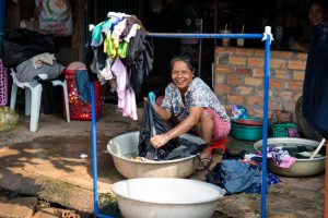Woman washing clothes for an article on Siem Reap travel tips