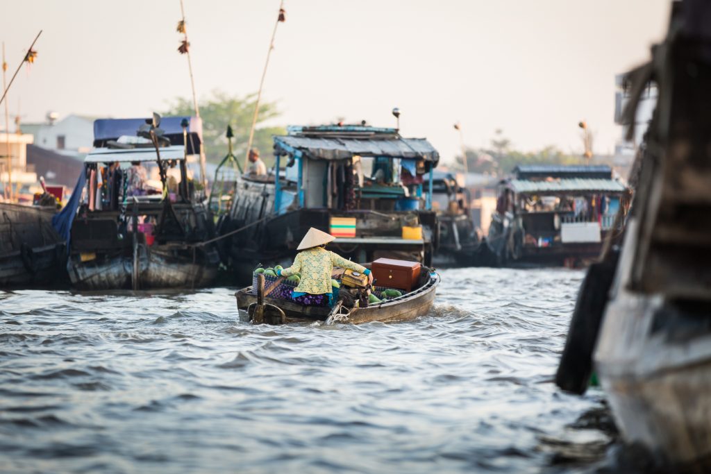 Woman driving boat at the Cai Rang Floating Markets