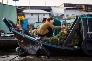 Women sorting pineapples at the Cai Rang Floating Markets