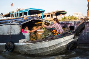 Workers transporting pineapples at the Cai Rang Floating Markets