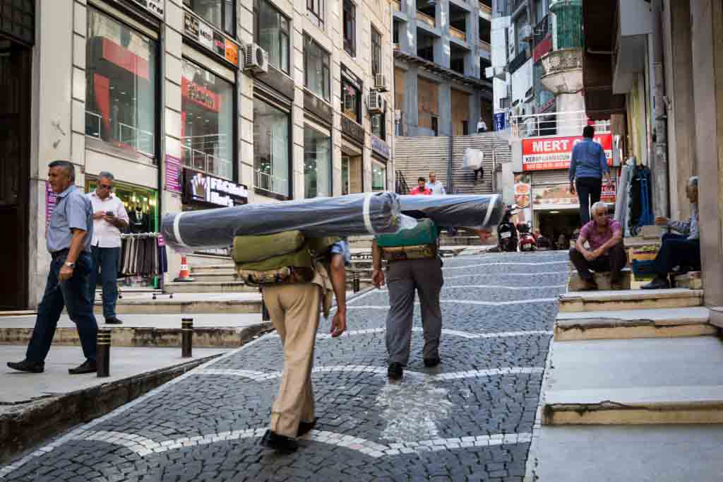 Men carrying fabric rolls for an article on Istanbul street photos