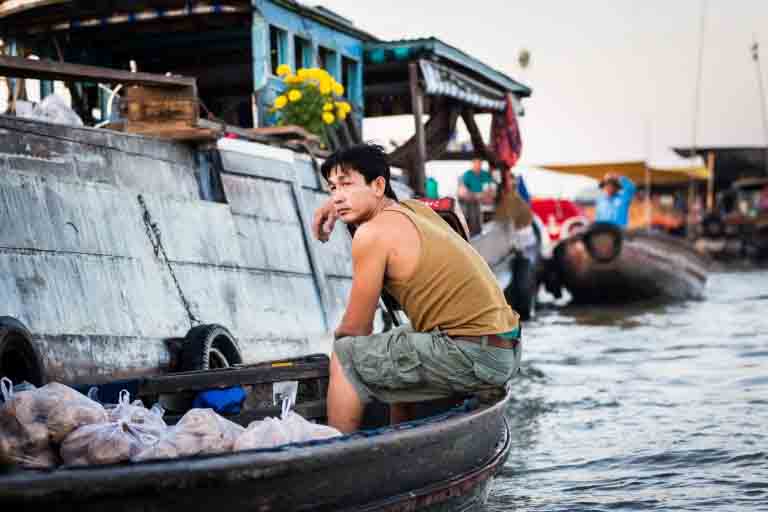 Worker in boat at the Cai Rang Floating Markets