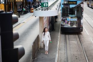 Woman at a ding ding station for a Hong Kong street photography series called the view from the ding ding