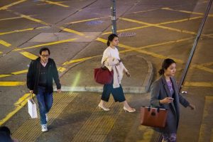 People crossing the street for a Hong Kong street photography series called the view from the ding ding