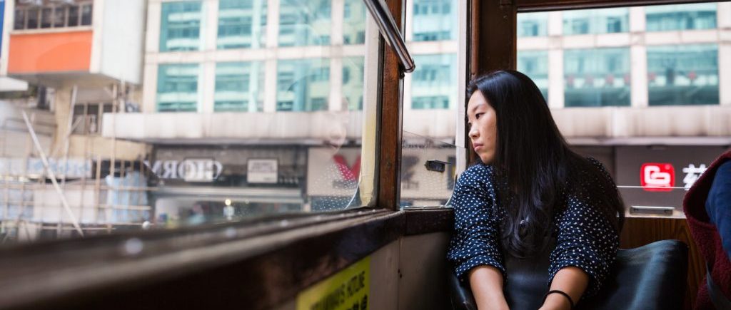 Woman looking out window of Hong Kong ding ding