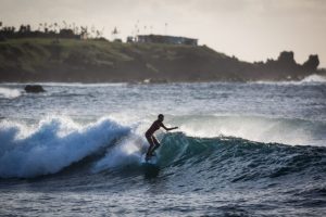 Surfer on a wave for an Easter Island travel guide