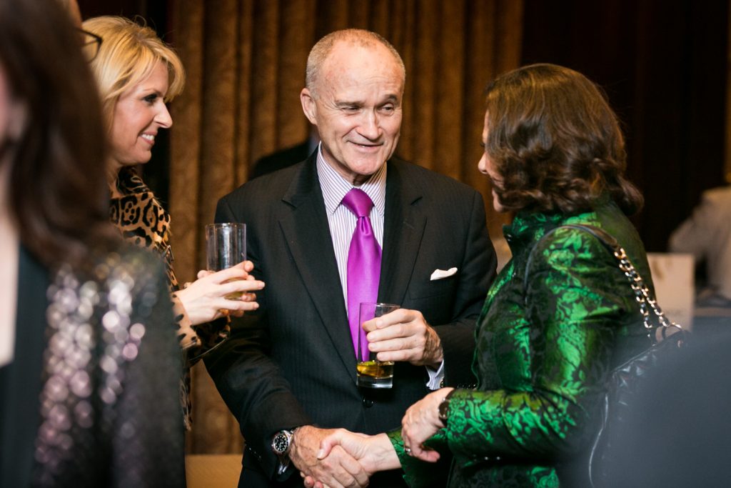 Business executives shaking hands at a cocktail party