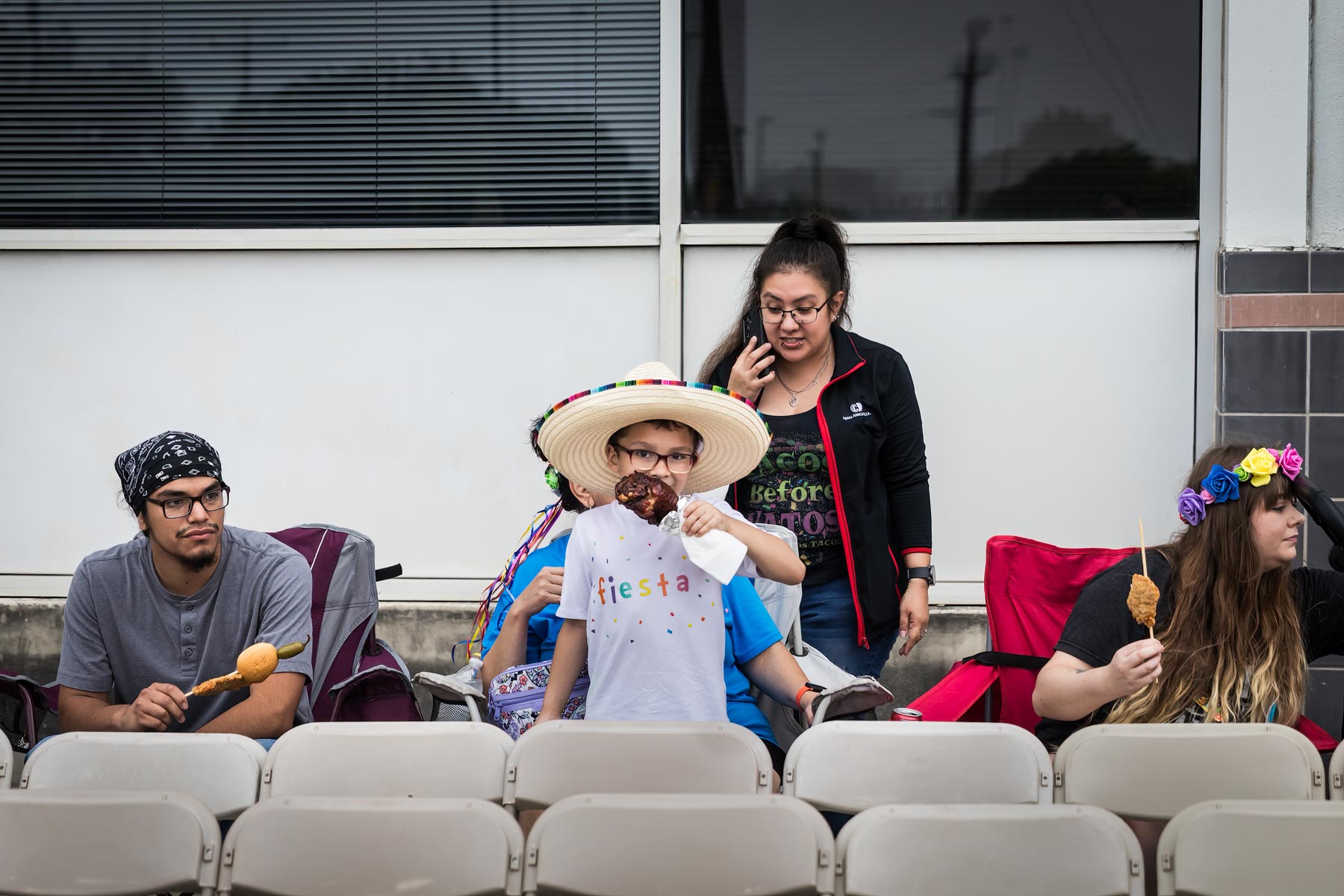 Little boy eating turkey let and wearing sombrero in front of family for an article on the Fiesta photo tips