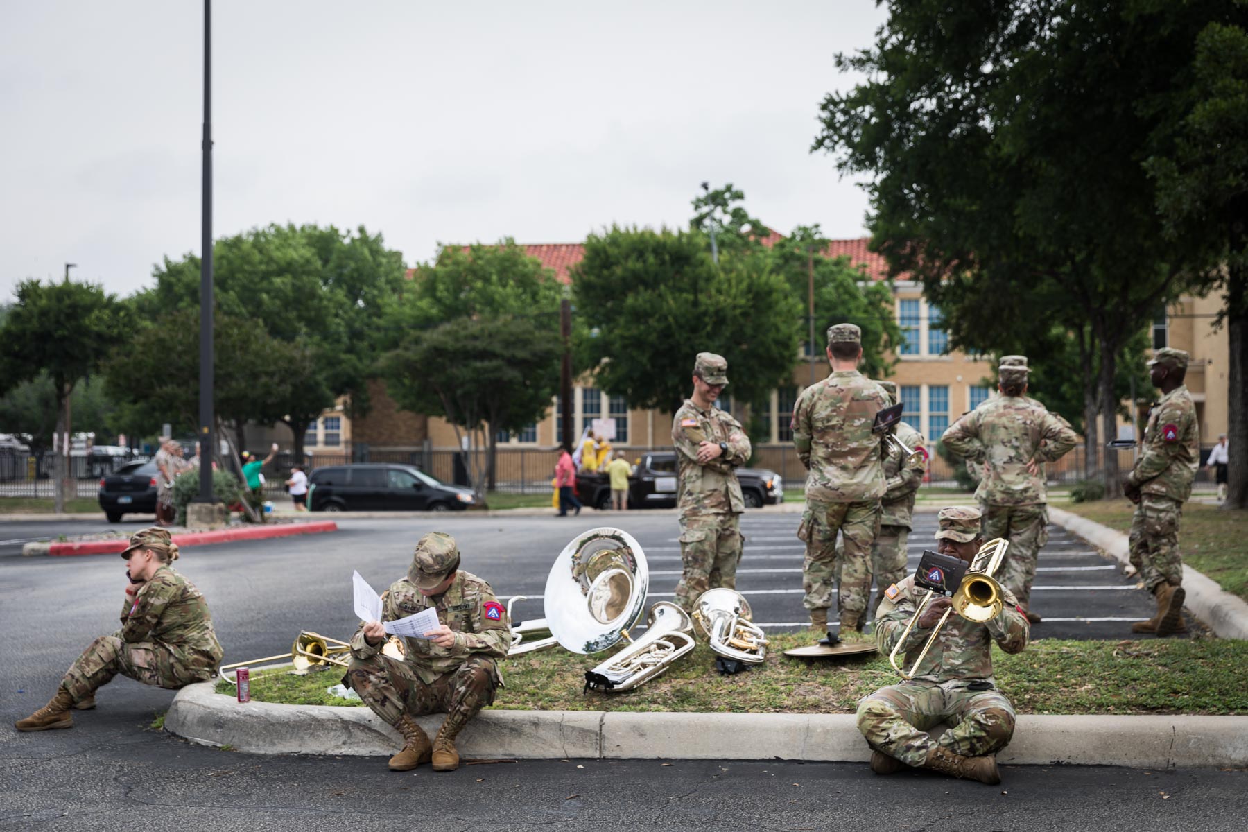 Military musicians in parking lot practicing instruments and talking on phone for an article on the Fiesta photo tips