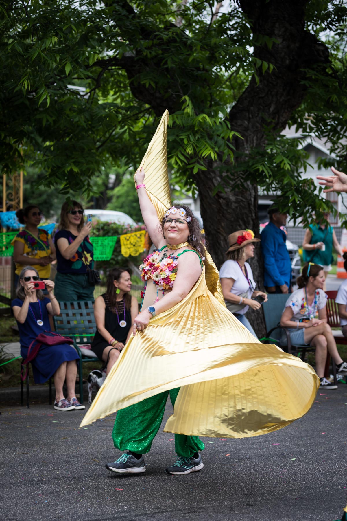 Woman twirling gold cape during King William Fair for an article on the Fiesta photo tips