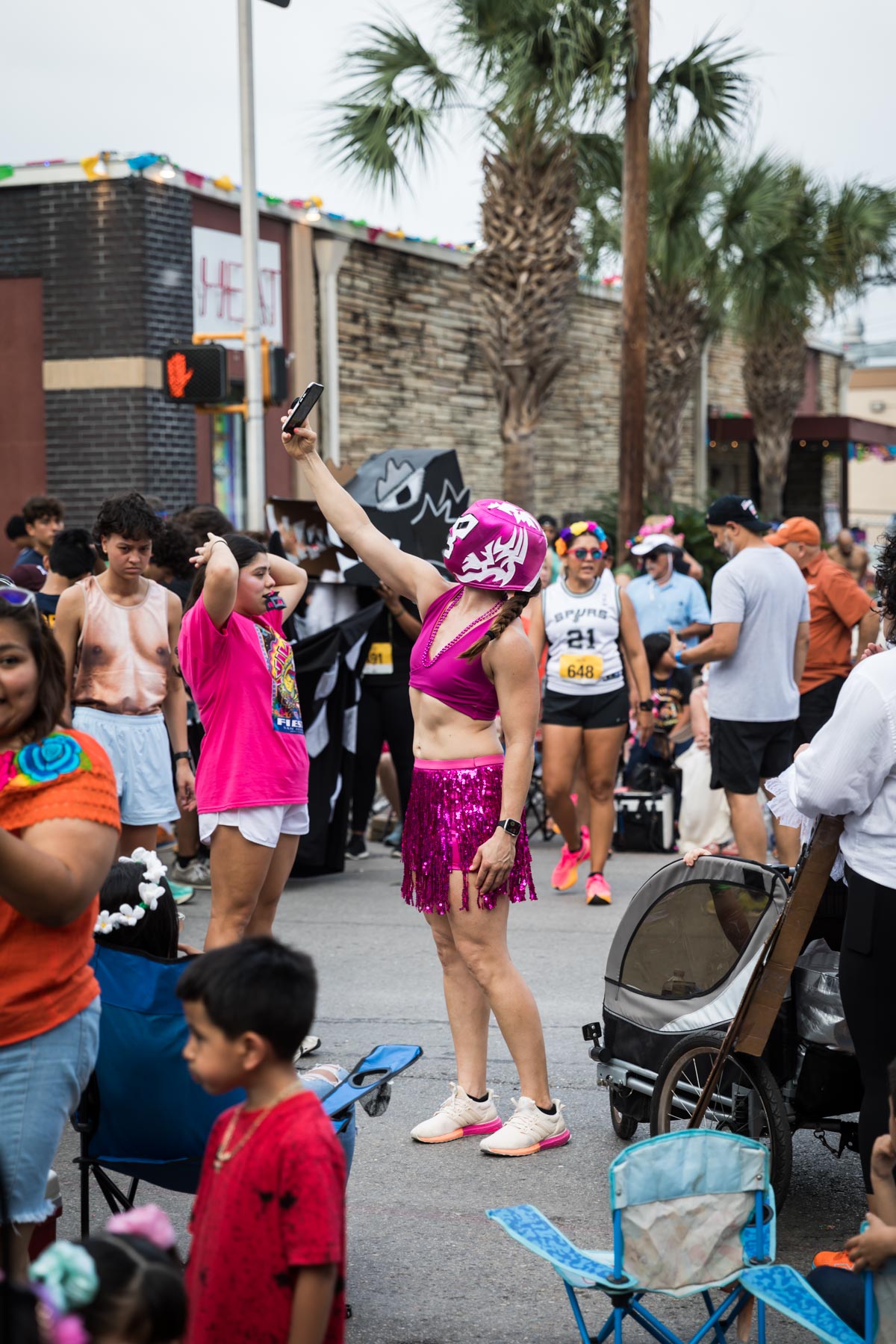 Woman jogger taking selfie while wearing pink outfit and mask for an article on the Fiesta photo tips