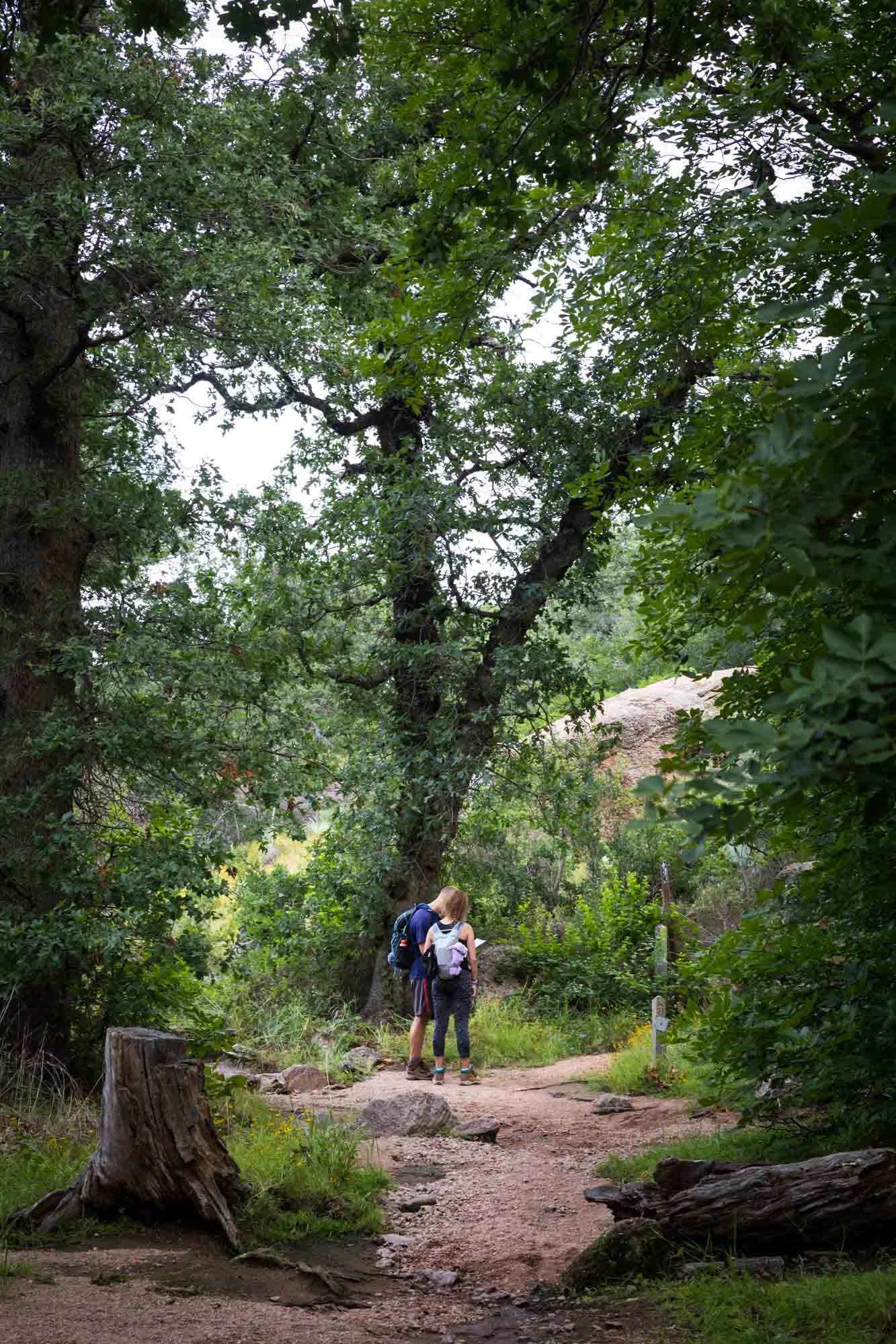 Couple looking at map on trail for an article on Enchanted Rock hiking trips