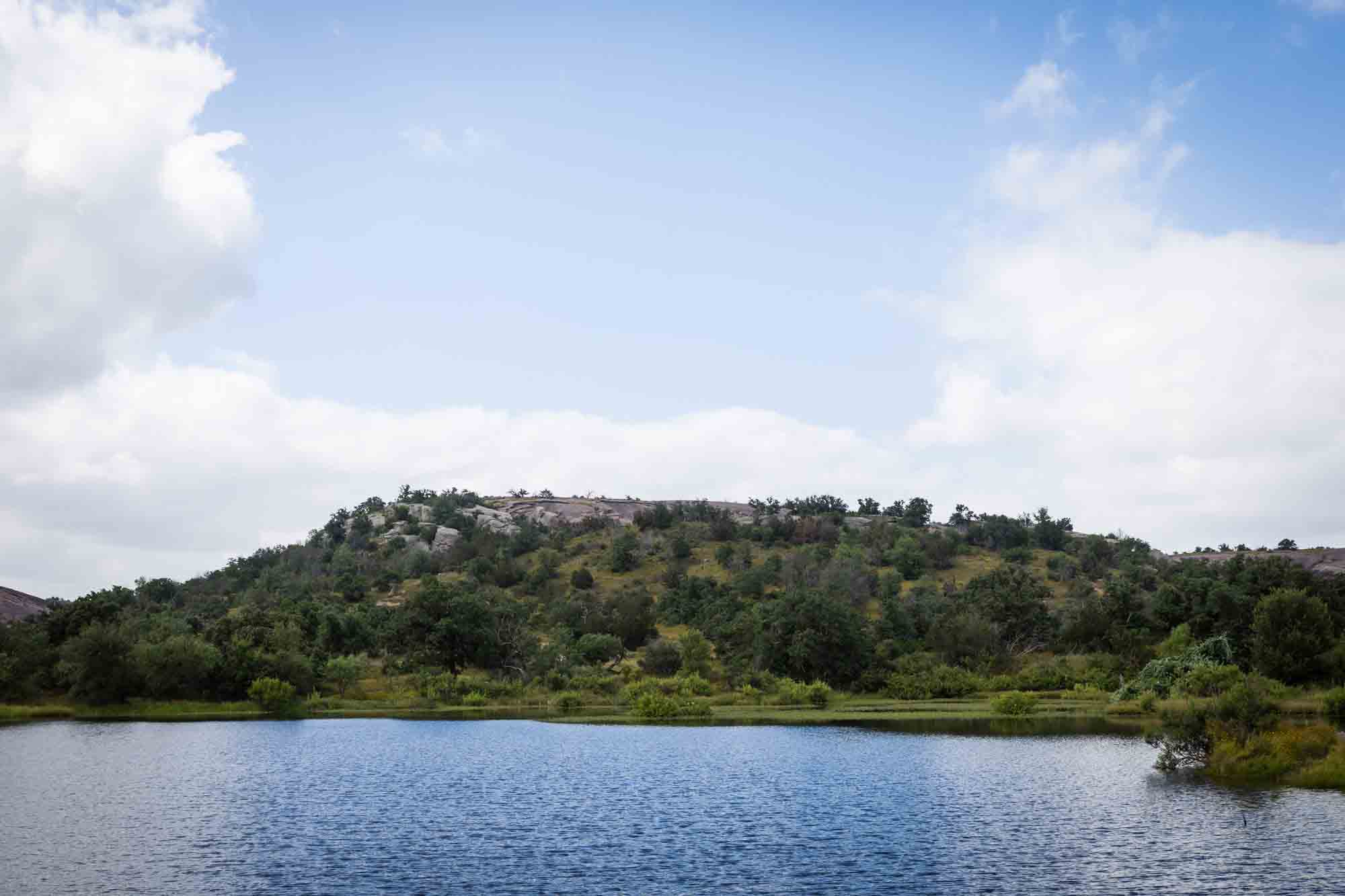 Moss Lake with rocks and trees in the background for an article on Enchanted Rock hiking trips