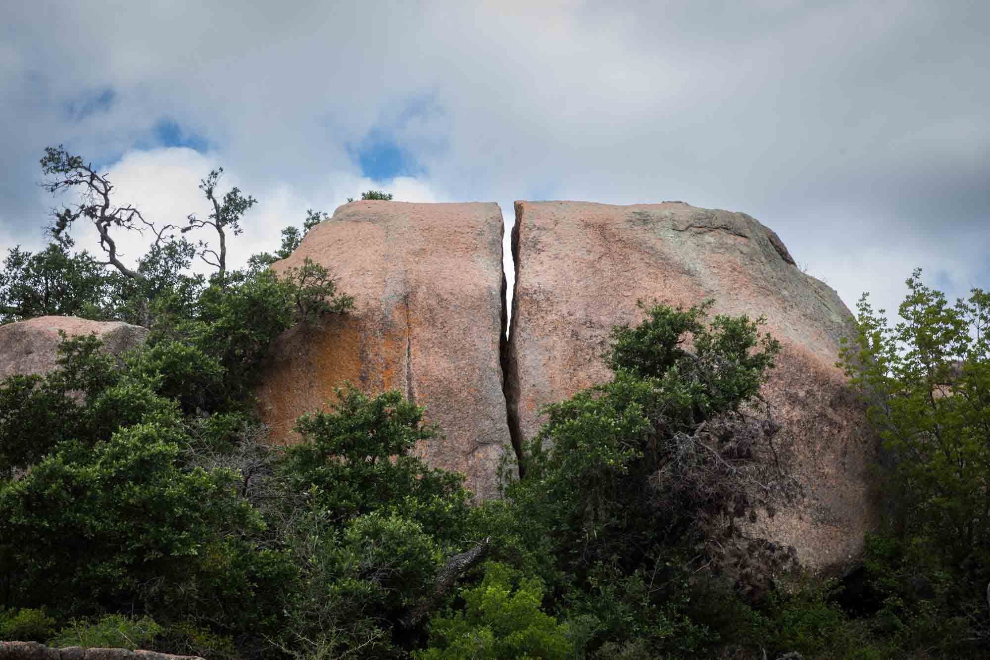 Large rock with a fissure down the middle for an article on Enchanted Rock hiking trips