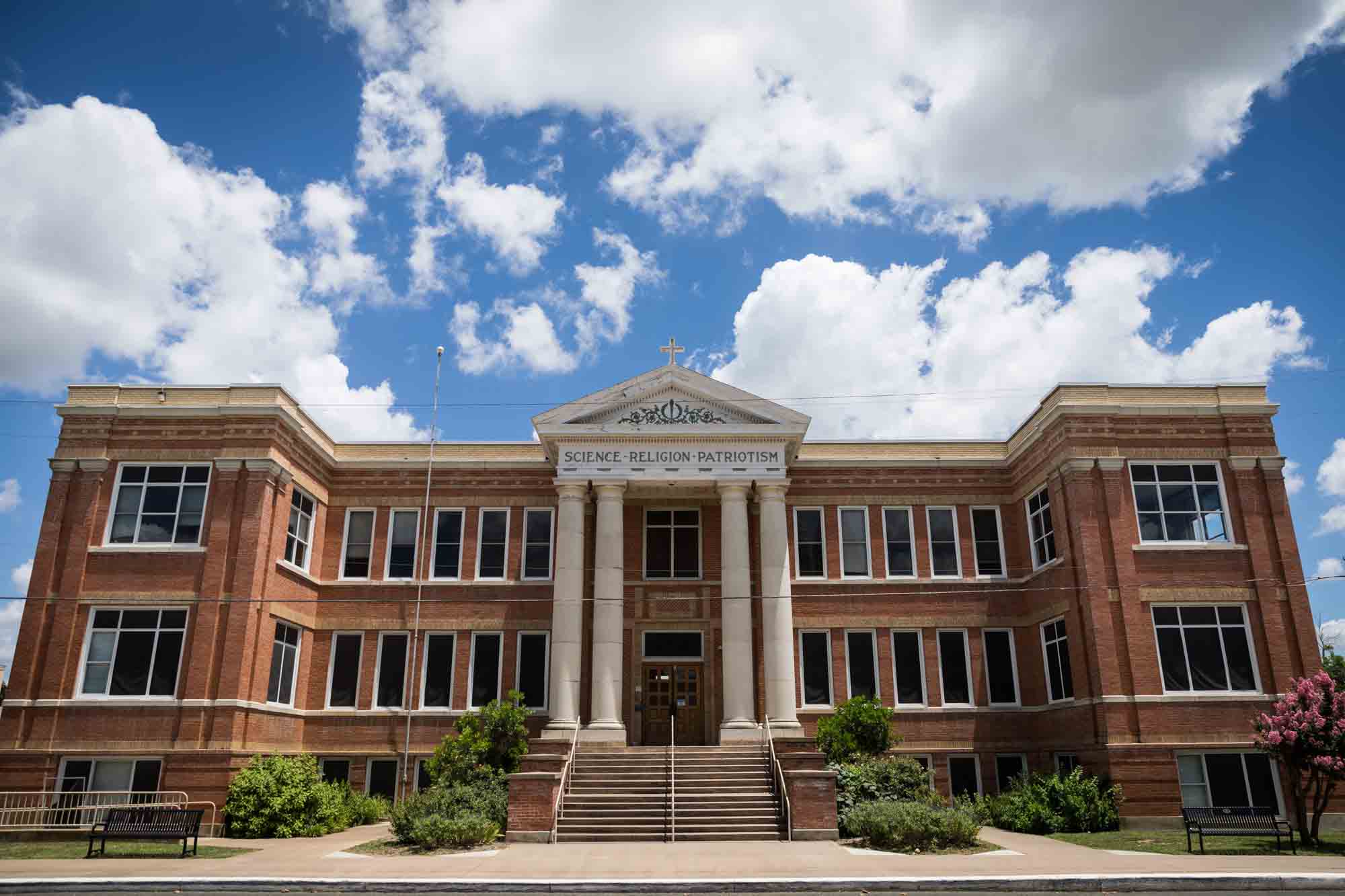 Large building with signage outside saying Science Religion Patriotism in Fredericksburg